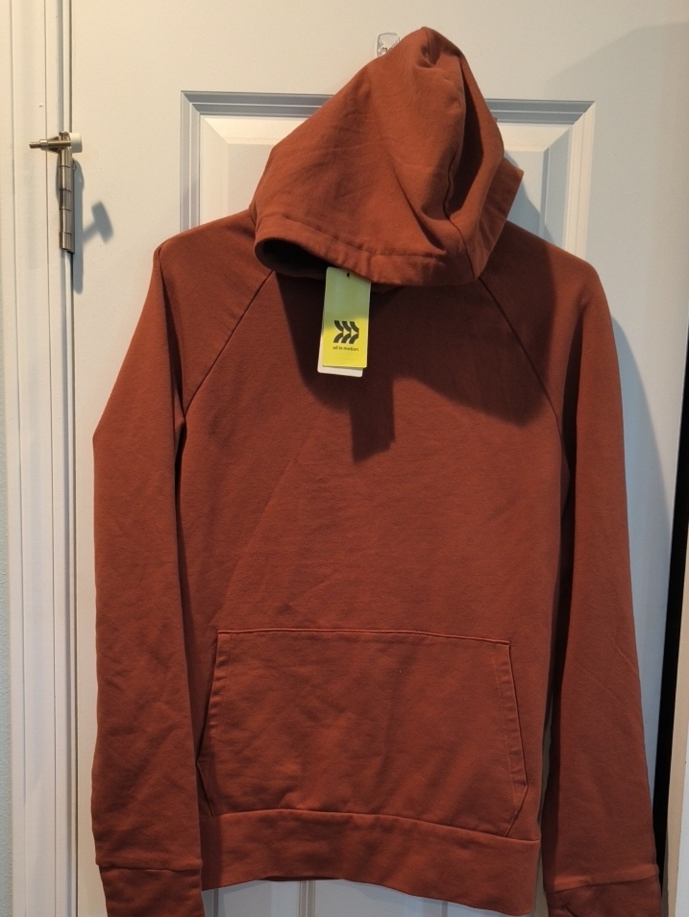 all in motion Neon Yellow Hangtag on Brown Garment